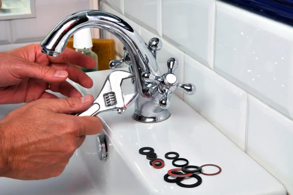 Plumber performing maintenance on a bathroom faucet in Royal Palm Beach