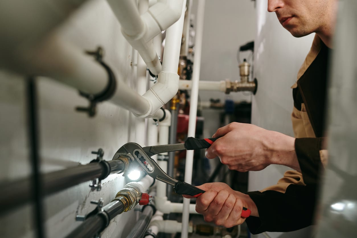 Plumbers maintaining commercial plumbing pipes in Royal Palm Beach