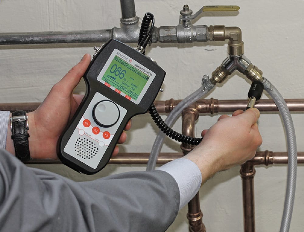 Plumber testing pipes with electronic leak detection equipment in Royal Palm Beach