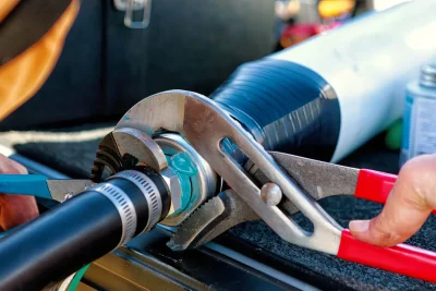 Technician tightening an industrial pipe connection in Royal Palm Beach