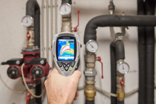 Plumber using a thermal imaging camera to inspect pipes in Royal Palm Beach