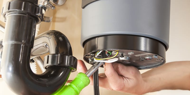 Technician repairing the heating element of a water heater in Royal Palm Beach